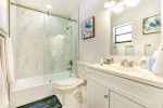 Elegant master ensuite features a white marble shower